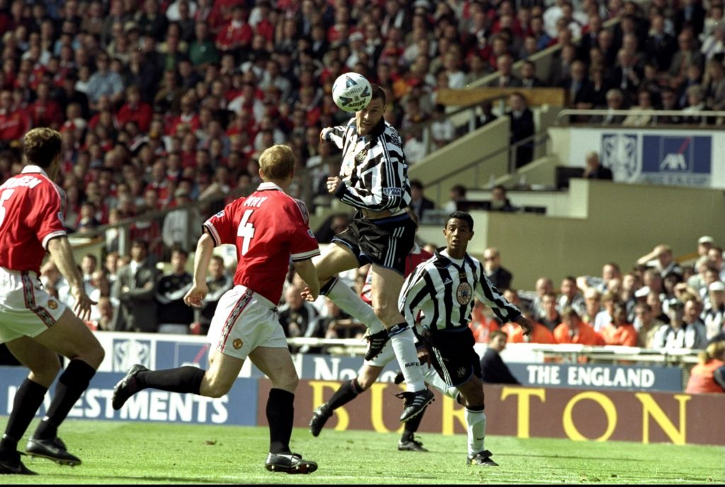 Duncan Ferguson heads the ball during a game between Newcastle United and Manchester United.