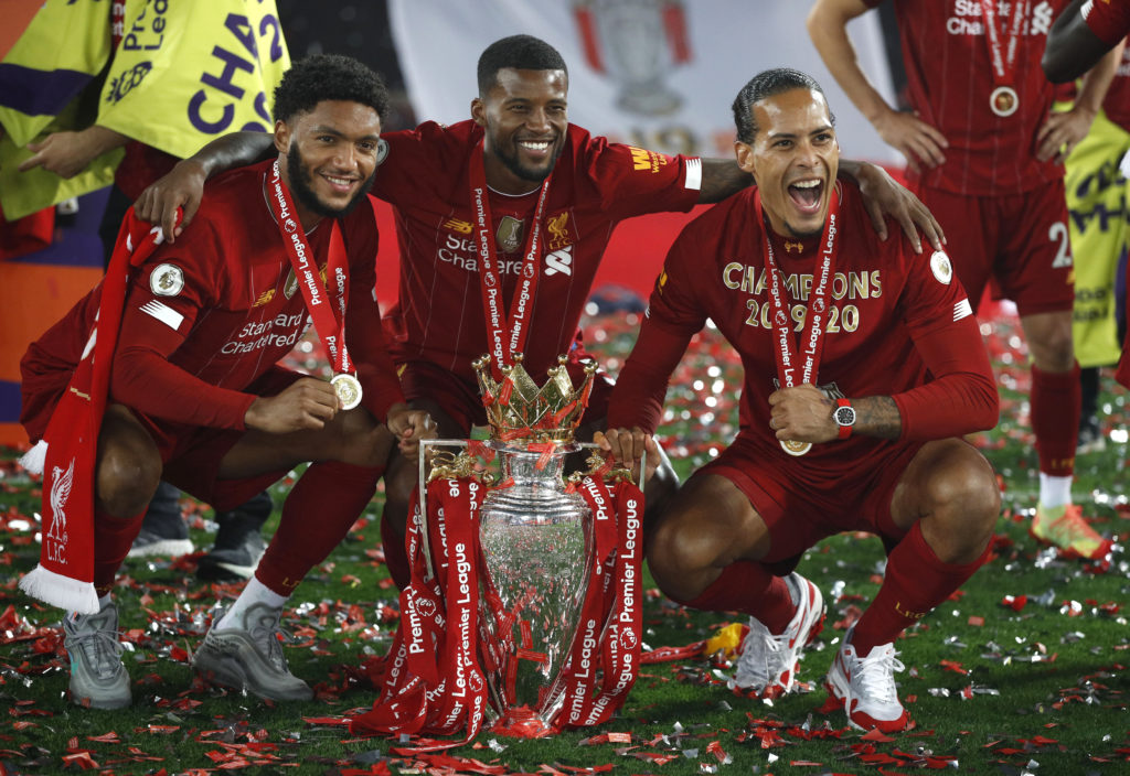 Gigi Wijnaldum poses with Joe Gomez, Virgil van Dijk and the Premier League trophy.