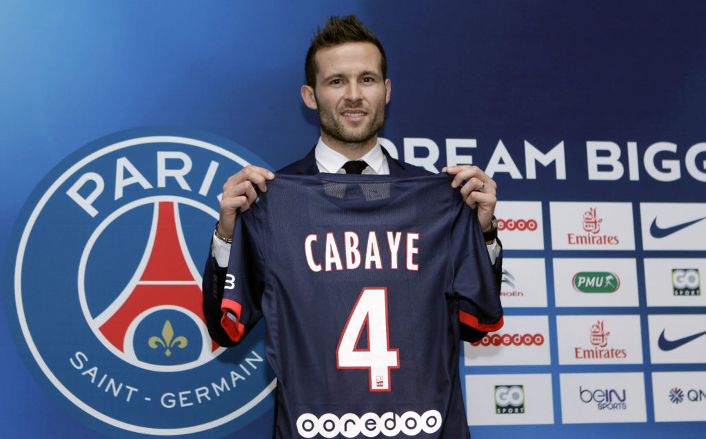 Yohan Cabaye holds a PSG shirt after signing for the club.