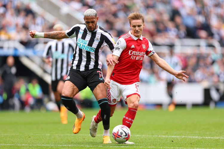 NEWCASTLE, ENGLAND - MAY 7: Joelinton of Newcastle United tackles Martin Odegaard of Arsenal during the Premier League match between Newcastle Unit...