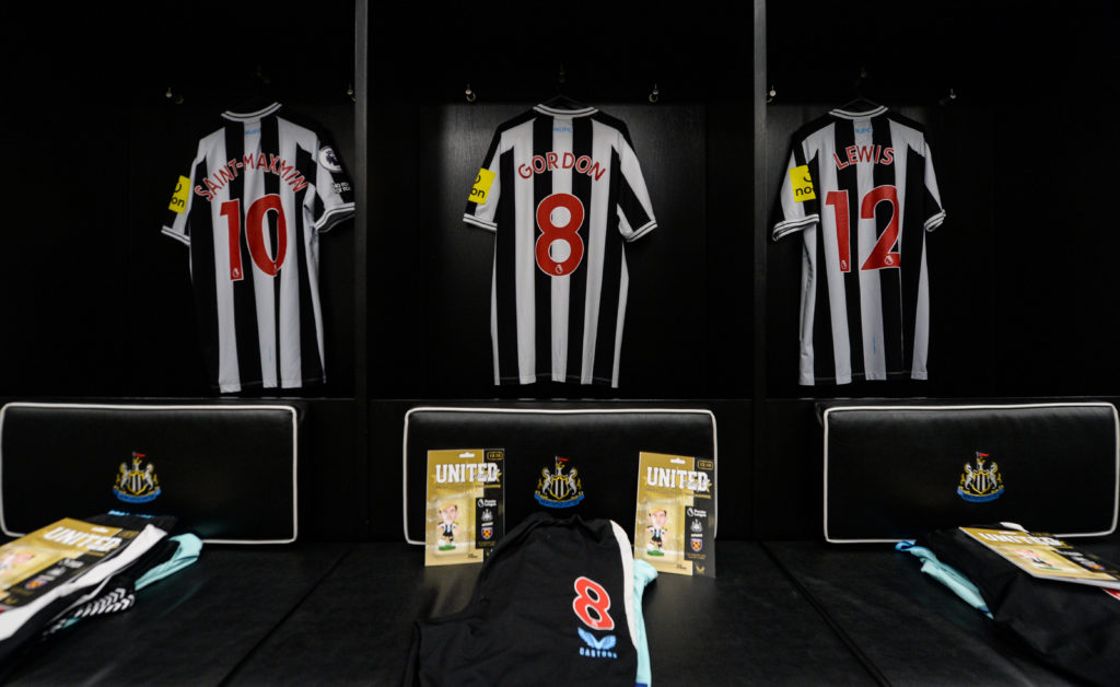Shirts of Allan Saint-Maximin, Anthony Gordon and Jamal Lewis in Newcastle United's dressing room.