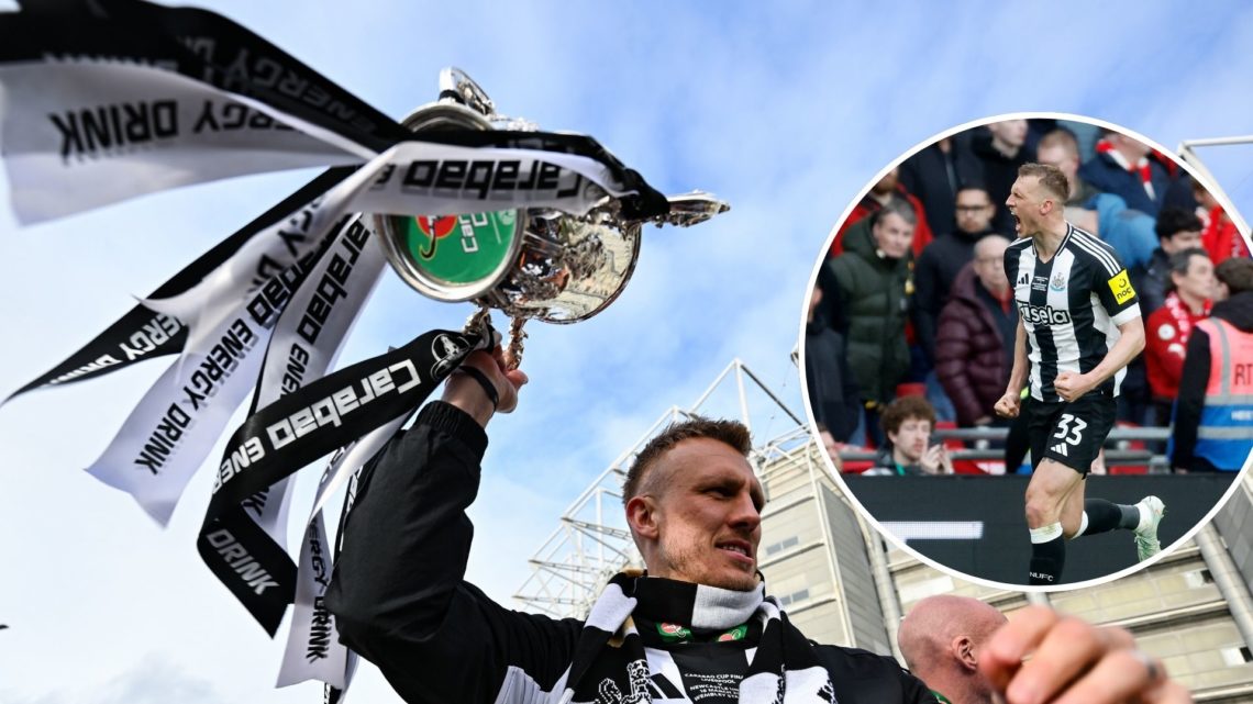 Dan Burn lifts the Carabao Cup winners trophy during the Newcastle United trophy parade and celebration on March 29, 2025 in Newcastle upon Tyne, E...
