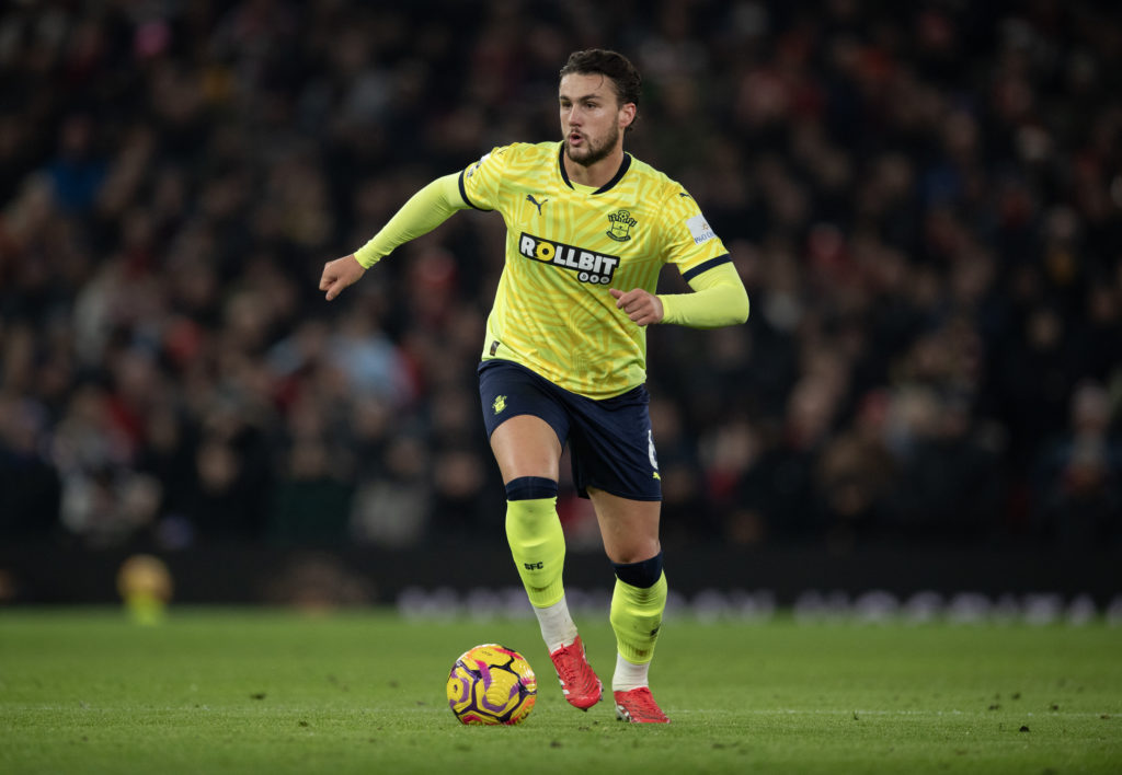 Taylor Harwood-Bellis carries the ball for Southampton against Manchester United in January 2025.