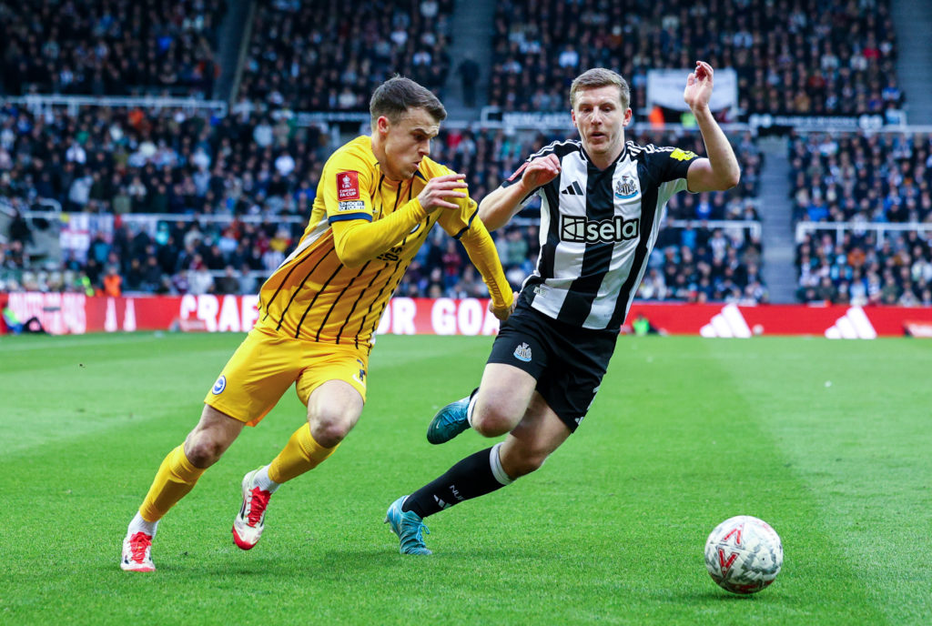 Matt Targett battles with Solly March during Newcastle United vs Brighton at St James' Park.