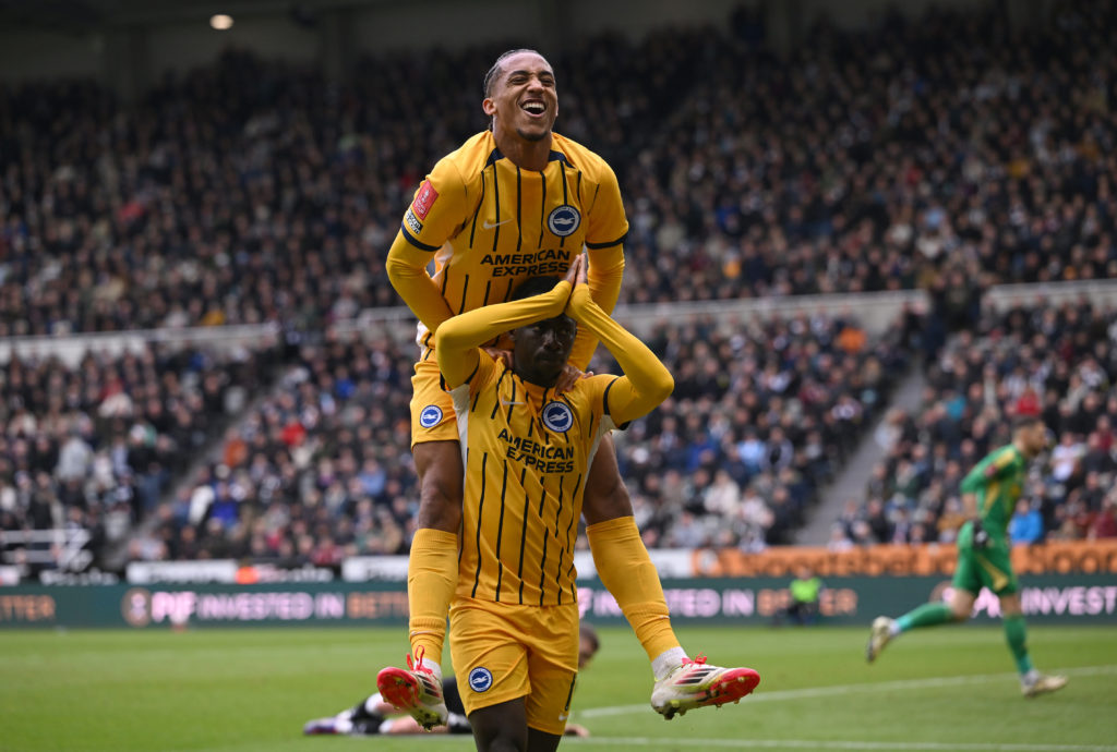 Joao Pedro jumps on Yankuba Minteh's shoulders.