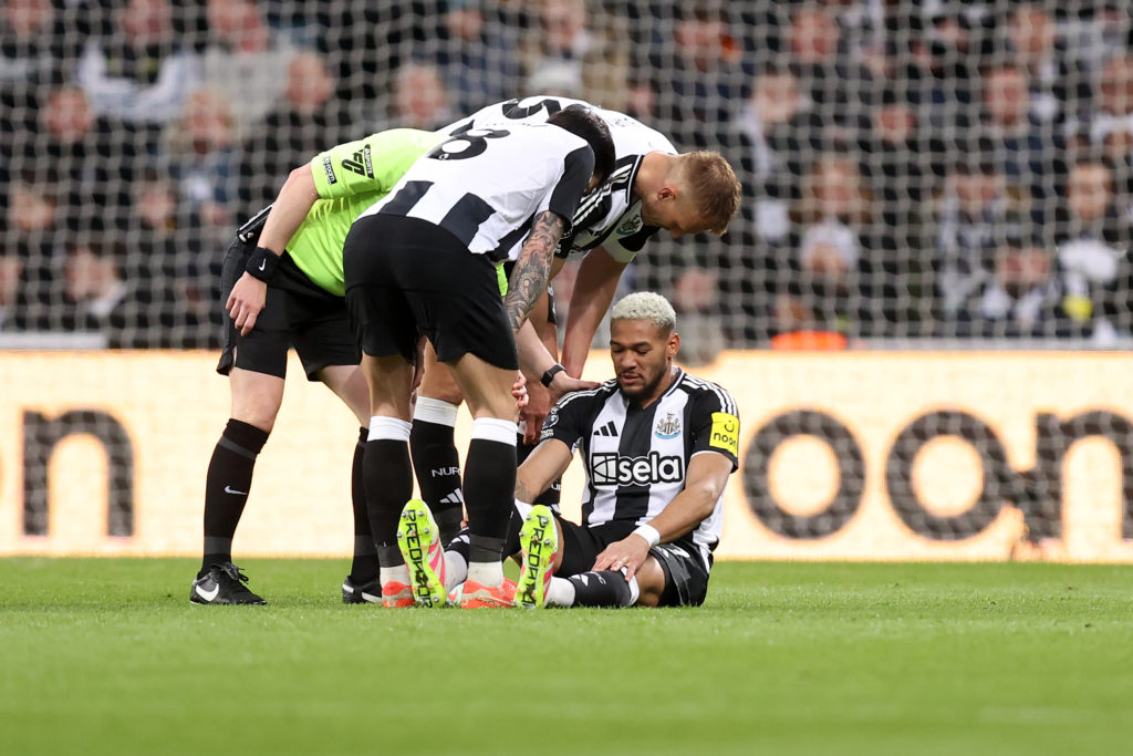 Joelinton on the floor injured during a game between Newcastle United and Brentford.