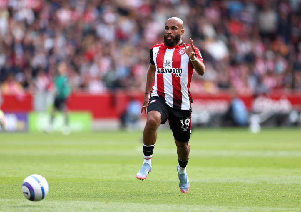 Brentford attacker Bryan Mbeumo running with the ball during a Premier League game against Fulham.