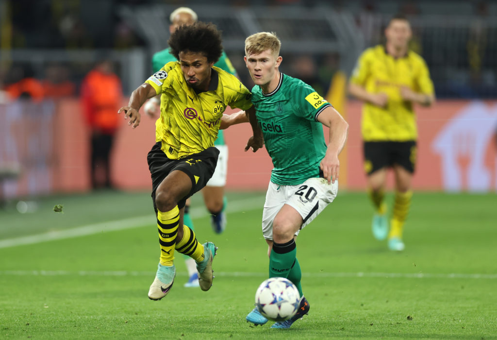 Karim Adeyemi and Lewis Hall challenge each other for possession during Borussia Dortmund vs Newcastle United in the Champions League.