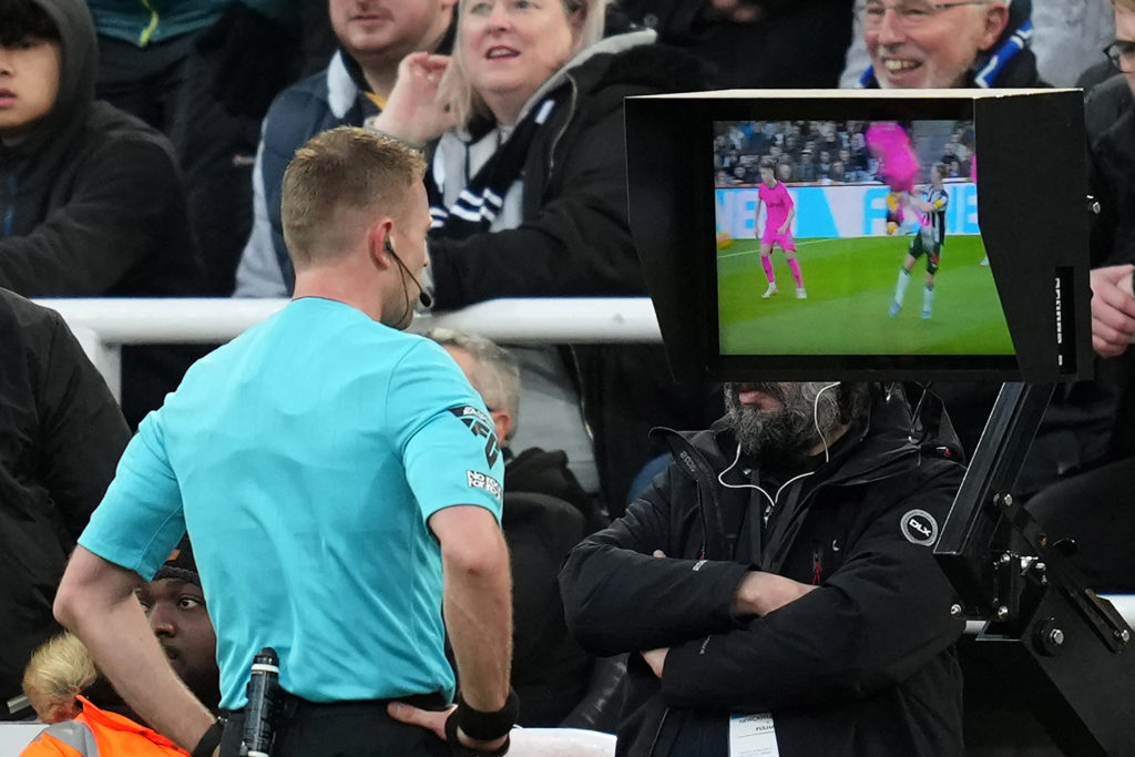 Premier League referee Samuel Barrott checks the pitch-side monitor after an incident between Fulham's Raul Jimenez during a game between Newcastle United and Fulham.
