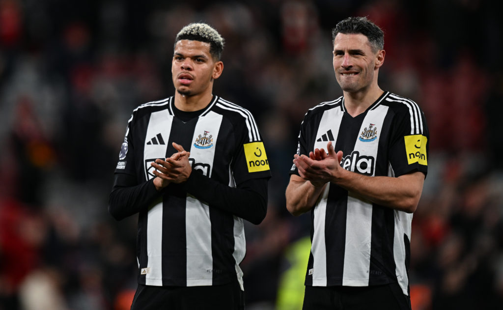 Will Osula and Fabian Schar applaud the Newcastle United fans after losing to Liverpool at Anfield in the Premier League.