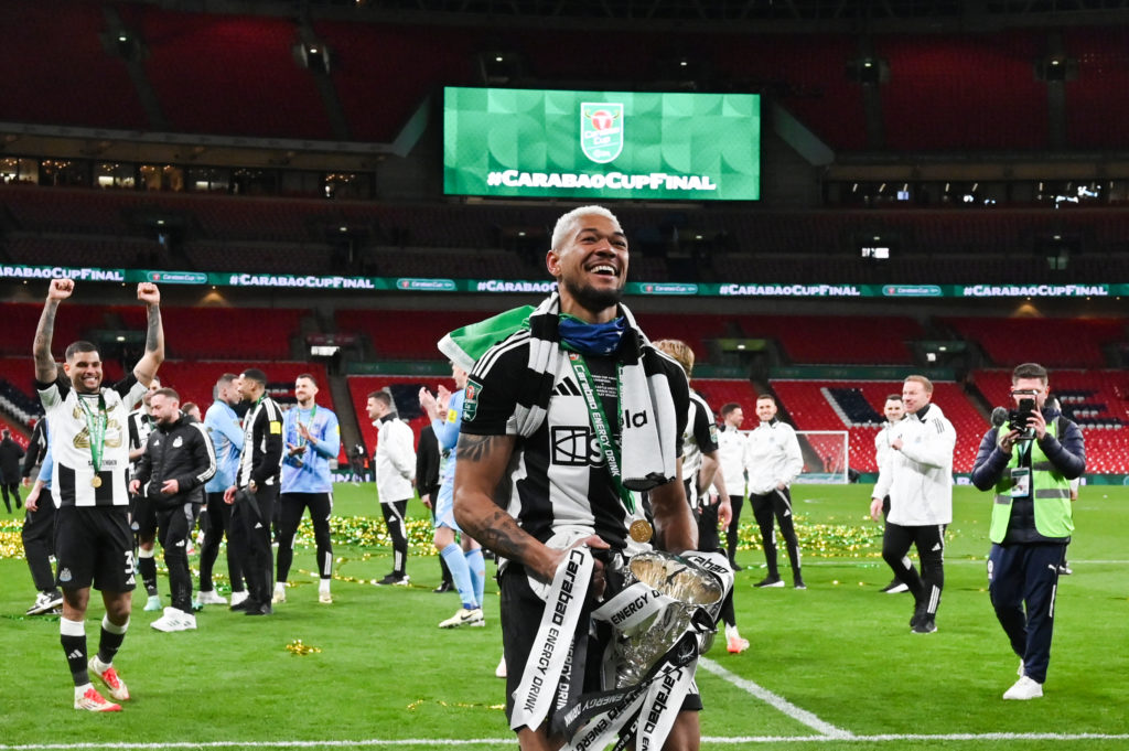 Joelinton holds the Carabao Cup trophy after Newcastle United's win over Liverpool at Wembley.