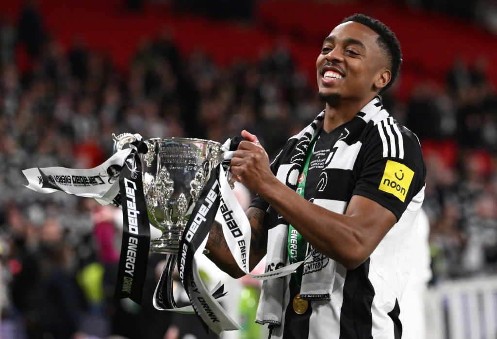 Joe Willock holds the Carabao Cup trophy after Newcastle United's win over Liverpool at Wembley.