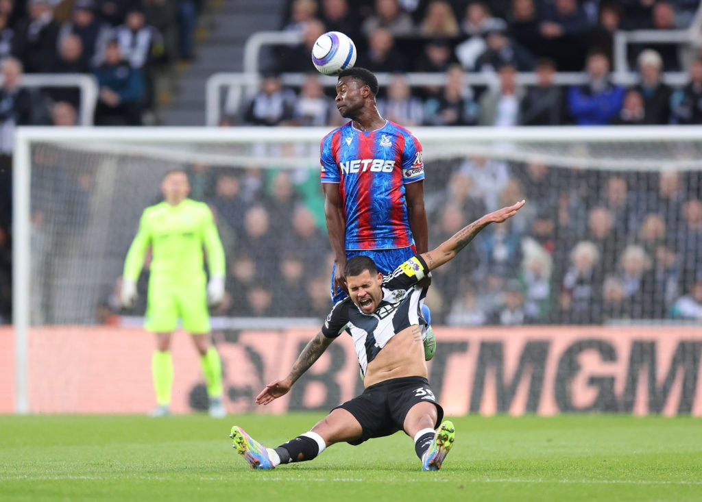 Marc Guehi heads the ball away for Crystal Palace during a Premier League game against Newcastle United.