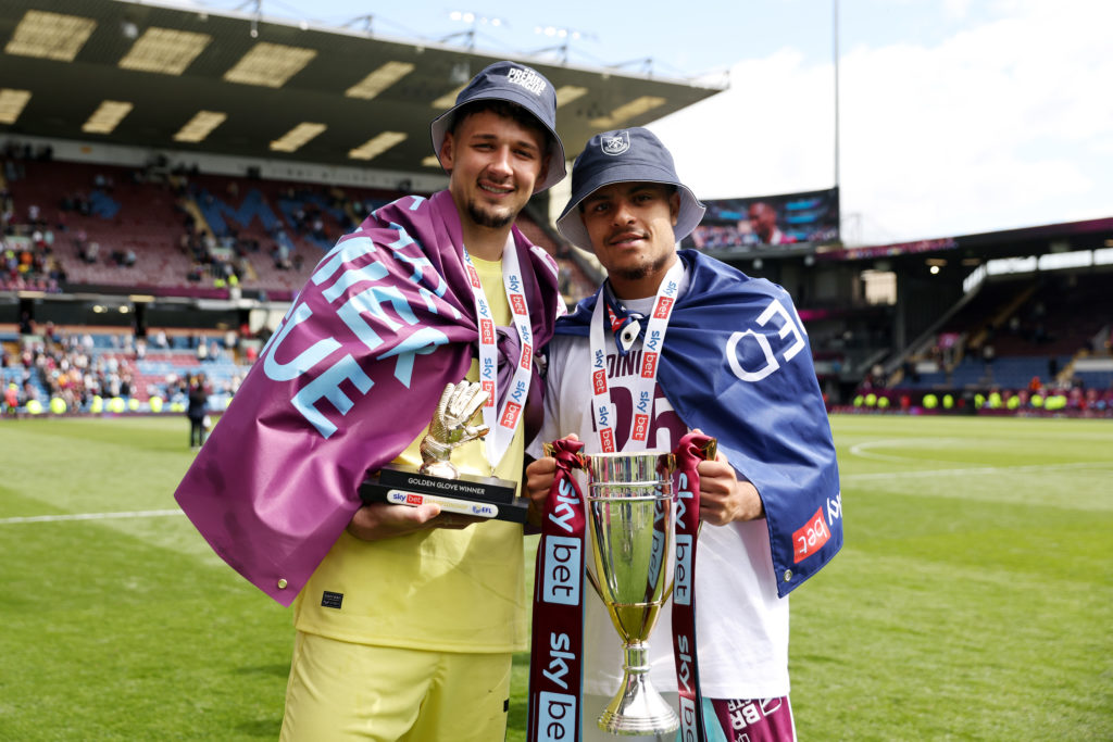 James Trafford and CJ Egan Riley pose with the Championship runners-up trophy.