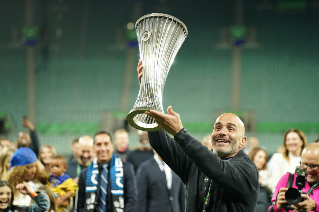 Chelsea manager Enzo Maresca lifts the UEFA Conference League trophy.
