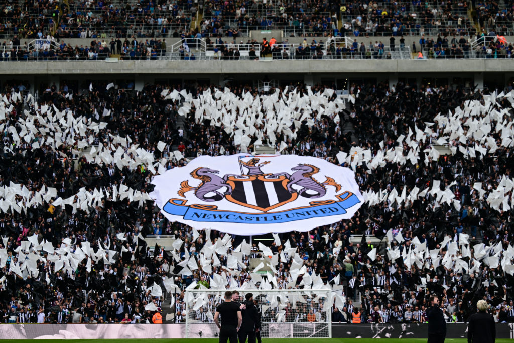 Newcastle United fans display a banner with the club crest at St James' Park before a Premier League game between Newcastle United and Everton.