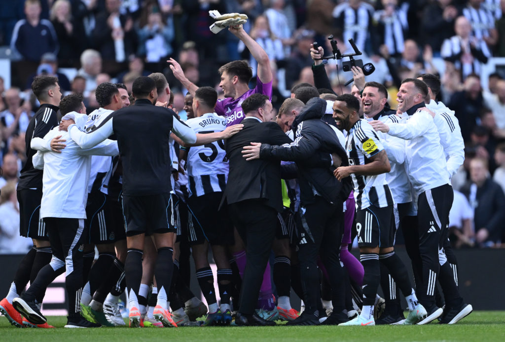 Newcastle United players celebrate qualifying for the Champions League after losing to Everton in the Premier League.