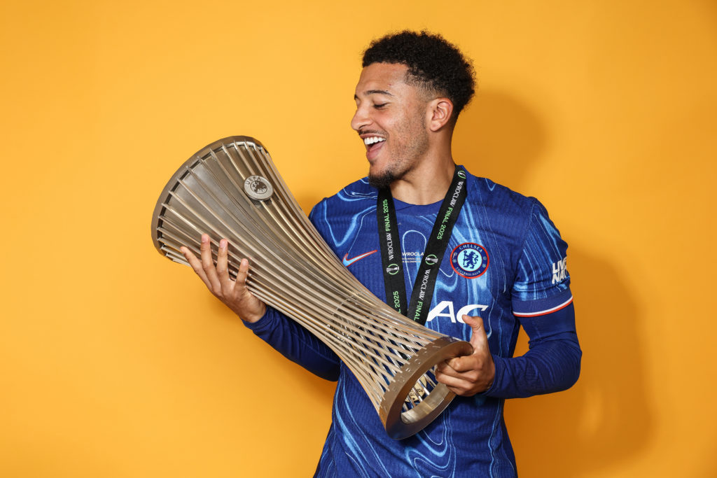 Jadon Sancho poses with the Conference League trophy after Chelsea beat Real Betis in the final.