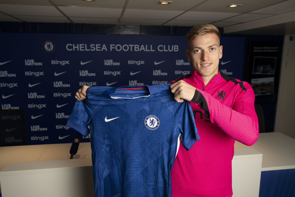 Liam Delap holds up a Chelsea shirt after signing for the Blues from Ipswich Town.