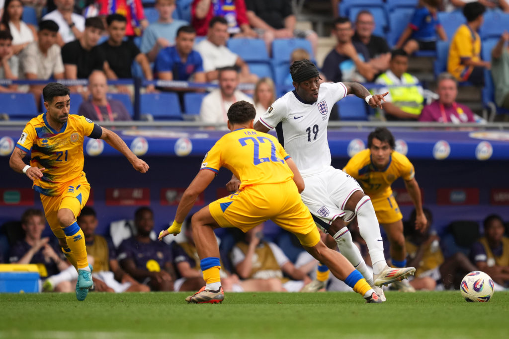 Noni Madueke runs with the ball while playing for England against Andorra.