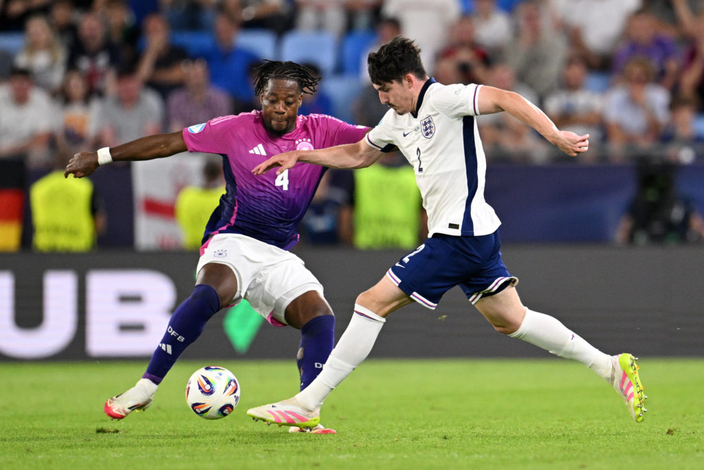 England defender Tino Livramento tackles Germany's Bright Arrey-Mbi in the U21 European Championship.