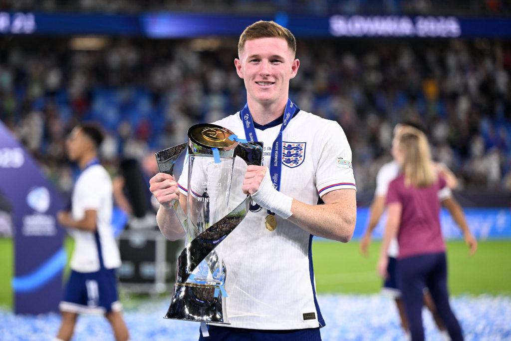 Elliot Anderson of England poses for a photograph with the UEFA European Under-21 Championship trophy.