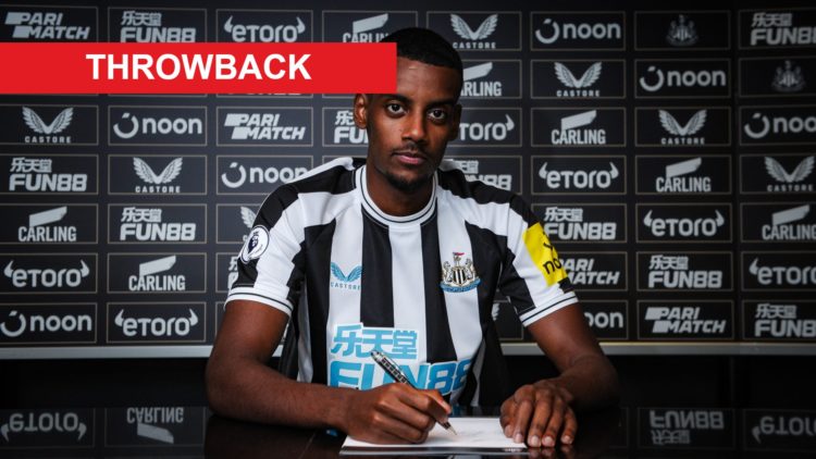 Alexander Isak is pictured signing his Newcastle United contract in August 2022.
