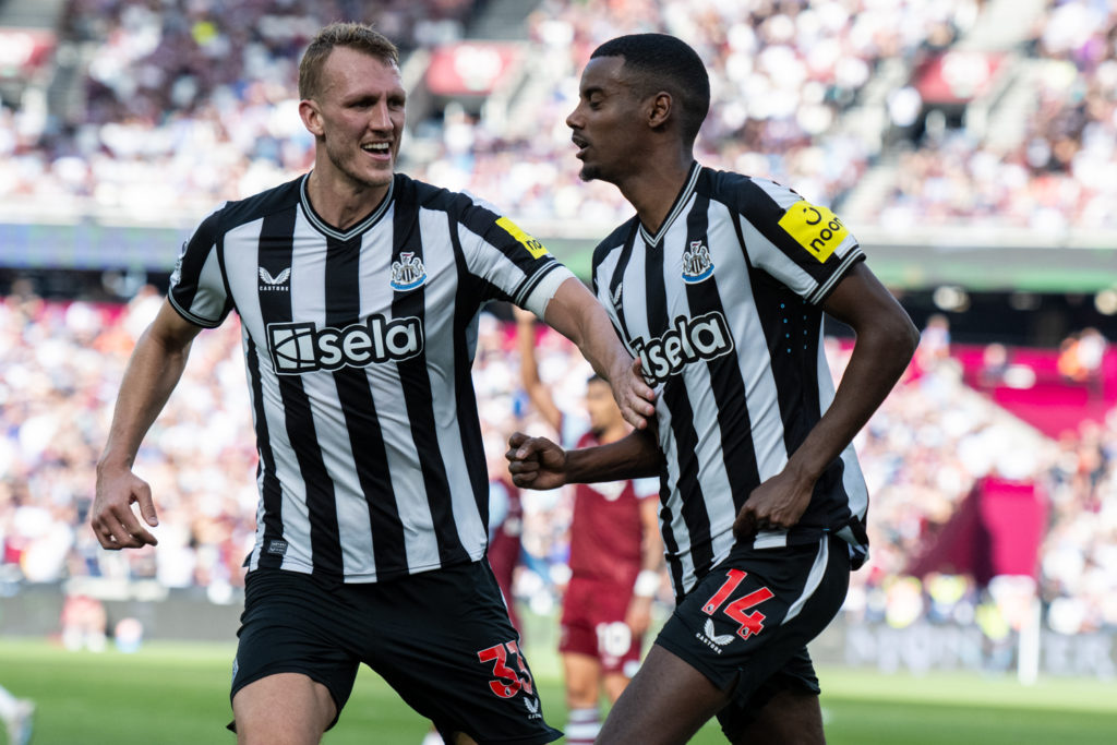 Dan Burn celebrates with Alexander Isak during a Premier League game between West Ham United and Newcastle United.