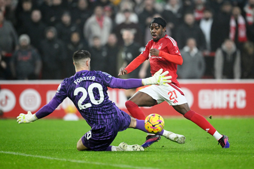 Anthony Elanga puts the ball past Fraser Forster during a Premier League game between Nottingham Forest and Tottenham Hotspur.