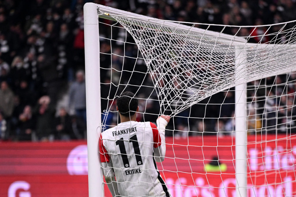 Hugo Ekitike hangs in the goalmouth during a Bundesliga game between Eintracht Frankfurt and Vfl Wolfsburg.