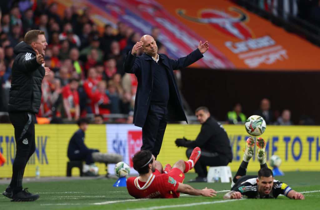 Eddie Howe and Arne Slot both react on the touchline during the 2025 Carabao Cup final between Liverpool and Newcastle United.