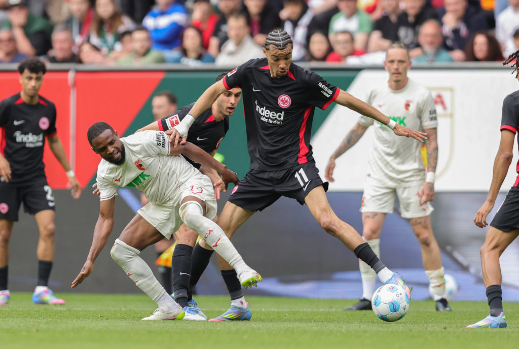 Hugo Ekitike challenges for the ball during a Bundesliga game between FC Augsburg and Eintracht Frankfurt.