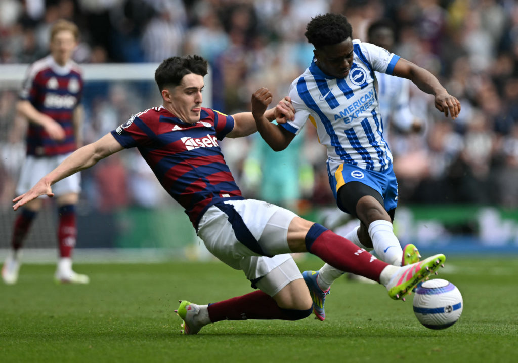 Tino Livramento slides in on Tariq Lamptey during a Premier League game between Brighton and Newcastle United.