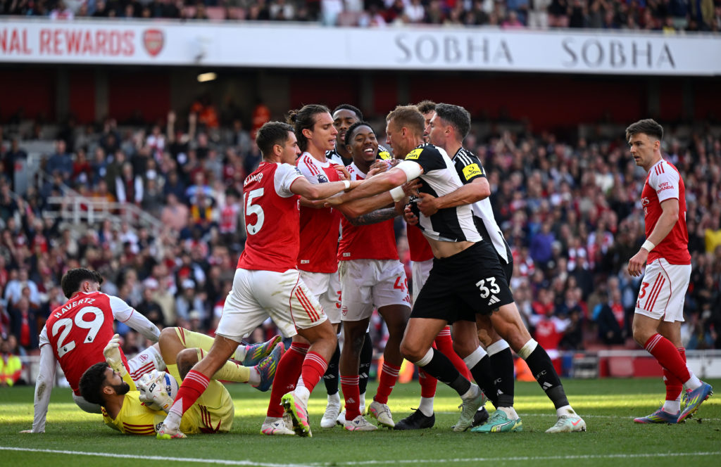 Newcastle United and Arsenal players clash during a Premier League game.