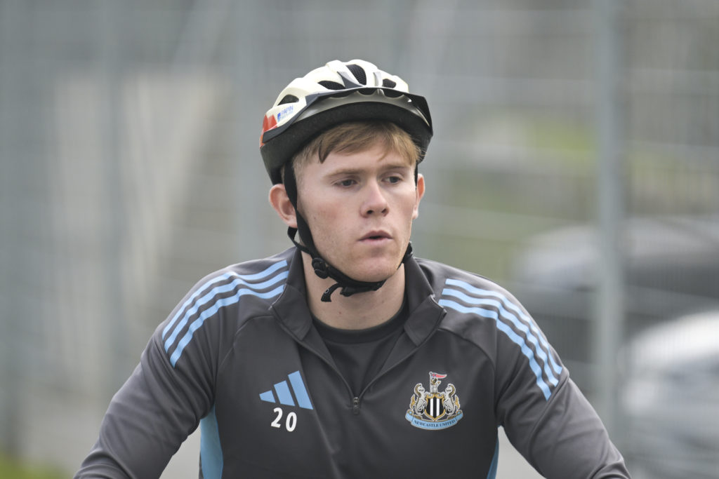 Lewis Hall riding a bike during Newcastle United's pre-season camp in Austria.