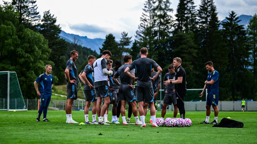Newcastle United players listen to Eddie Howe during a pre-season training camp.