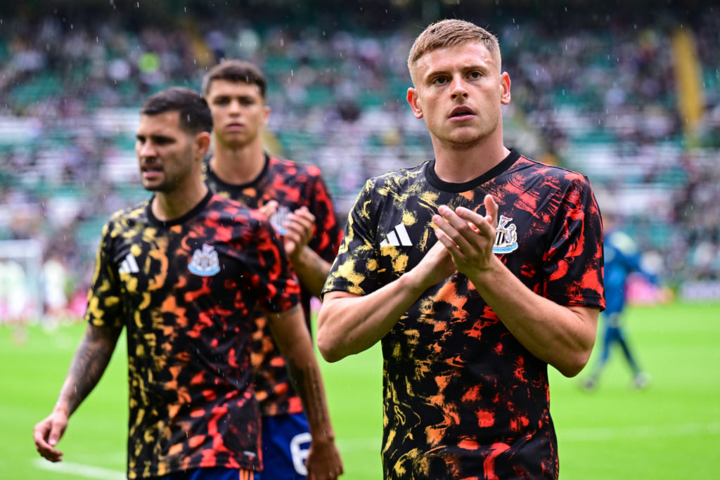 Harvey Barnes, Bruno Guimaraes and Lewis Miley applaud the fans during a friendly between Newcastle United and Celtic.