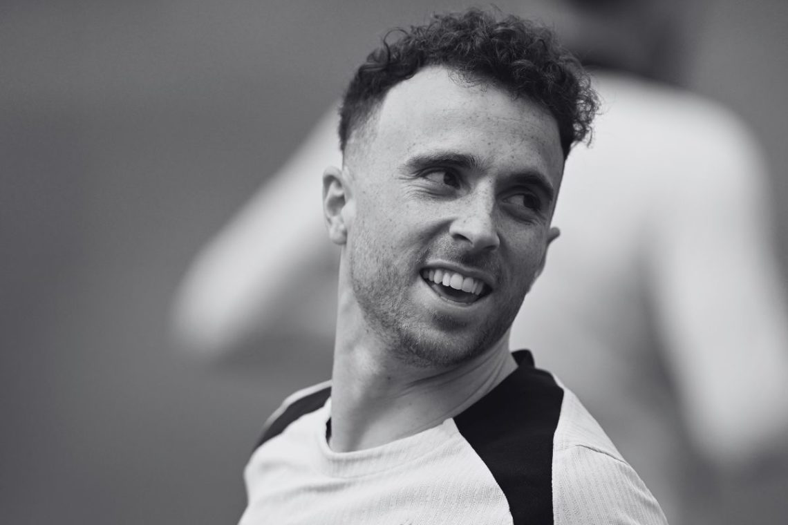 A black and white close up image of Diogo Jota in Liverpool training.