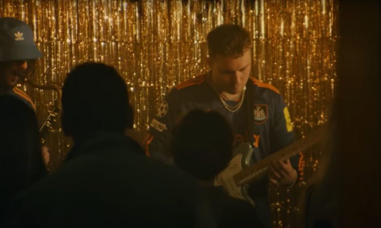 Sam Fedner plays guitar wearing the new Newcastle third shirt in a trailer on the club's YouTube channel.