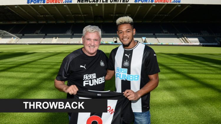 Steve Bruce and Joelinton pose with a Newcastle shirt at St. James' Park in 2019. A banner that reads 'throwback'