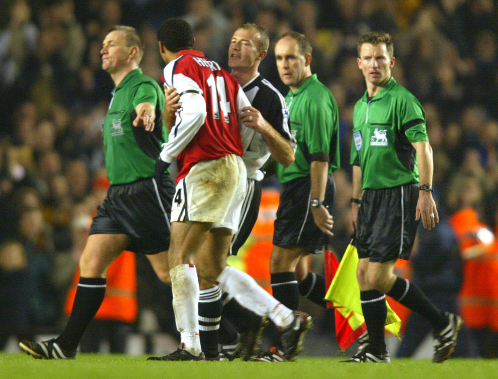 Thierry Henry of Arsenal is held back by Alan Shearer of Newcastle as he argues with referee Graham Poll at the end of the FA Barclaycard Premiership match between Arsenal and Newcastle United.