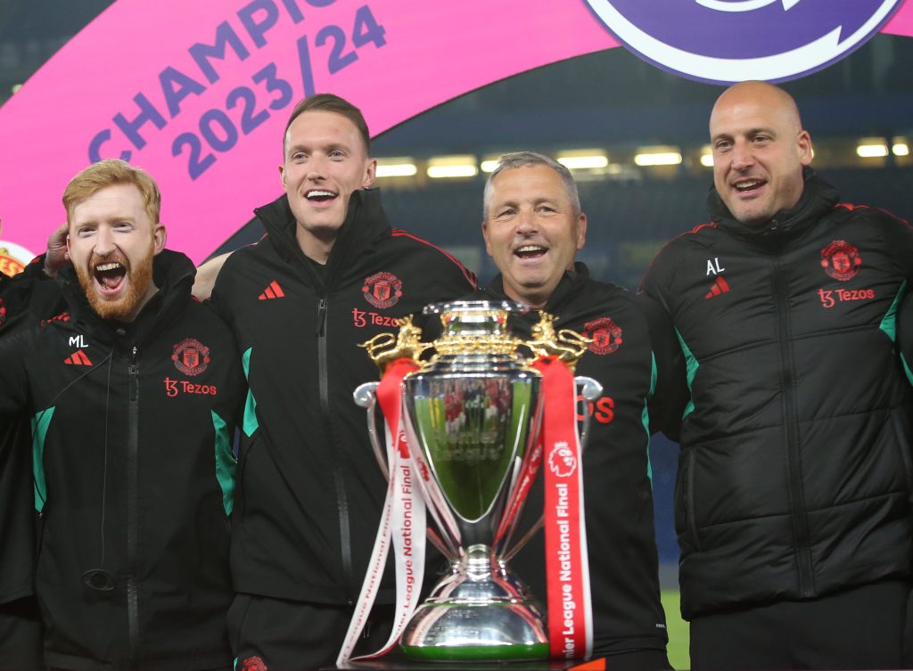 Adam Lawrence manager of Manchester United U18 and Phil Jones coach of Manchester United U18 celebrate with the U18 Premier League National Final trophy.