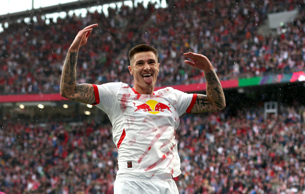 Benjamin Sesko celebrates scoring a goal in a Bundesliga game between Rb Leipzig and FC Augsburg.