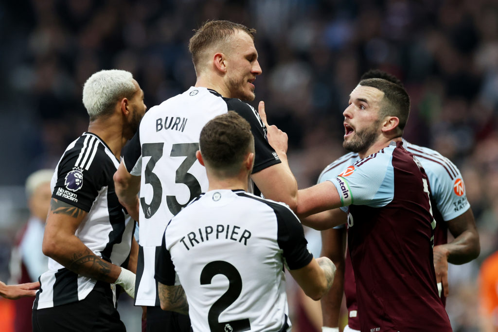 John McGinn and Dan Burn clash during Newcastle United vs Aston Villa.
