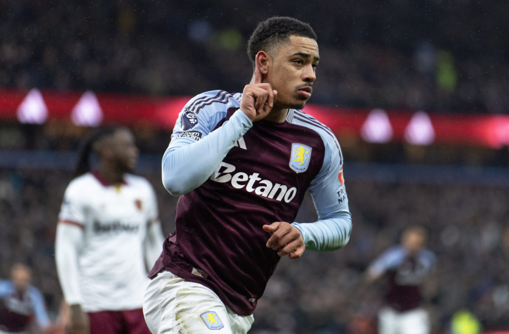 Jacob Ramsey points to his ear in celebration after scoring for Aston Villa.
