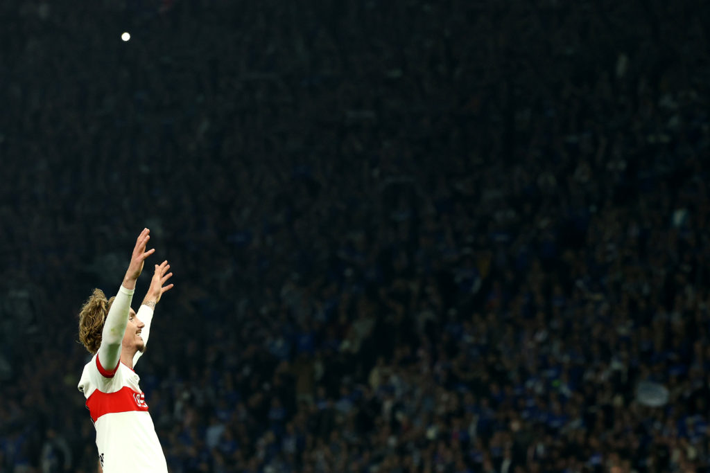 Nick Woltemade lifts his arms in the air in celebration.