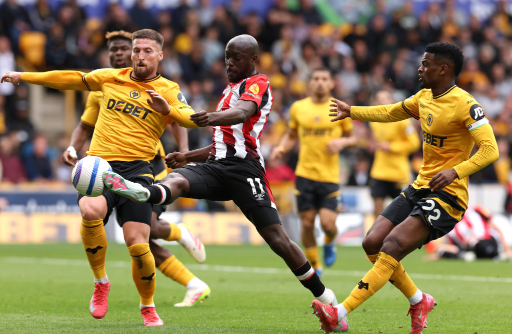 Yoane Wissa challenges for the ball during a Premier League game between Wolves and Brentford.