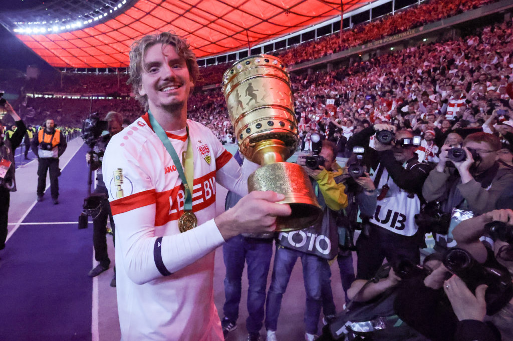 Nick Woltemade celebrates with the trophy after winning the German Cup with Stuttgart.
