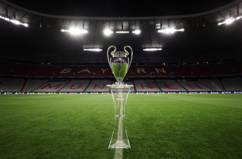 The Champions League trophy on a stand at the Allianz Arena.