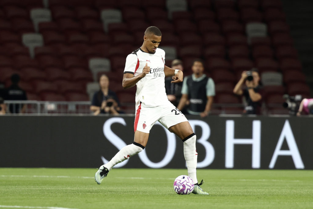 Malick Thiaw passes the ball during an AC Milan friendly against Arsenal.